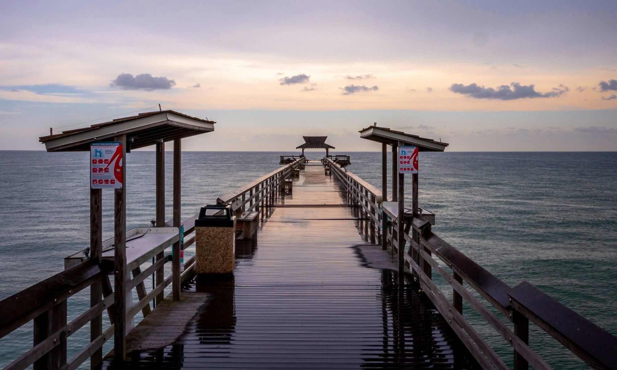 The Naples Pier stretching out over the Gulf of Mexico at dawn