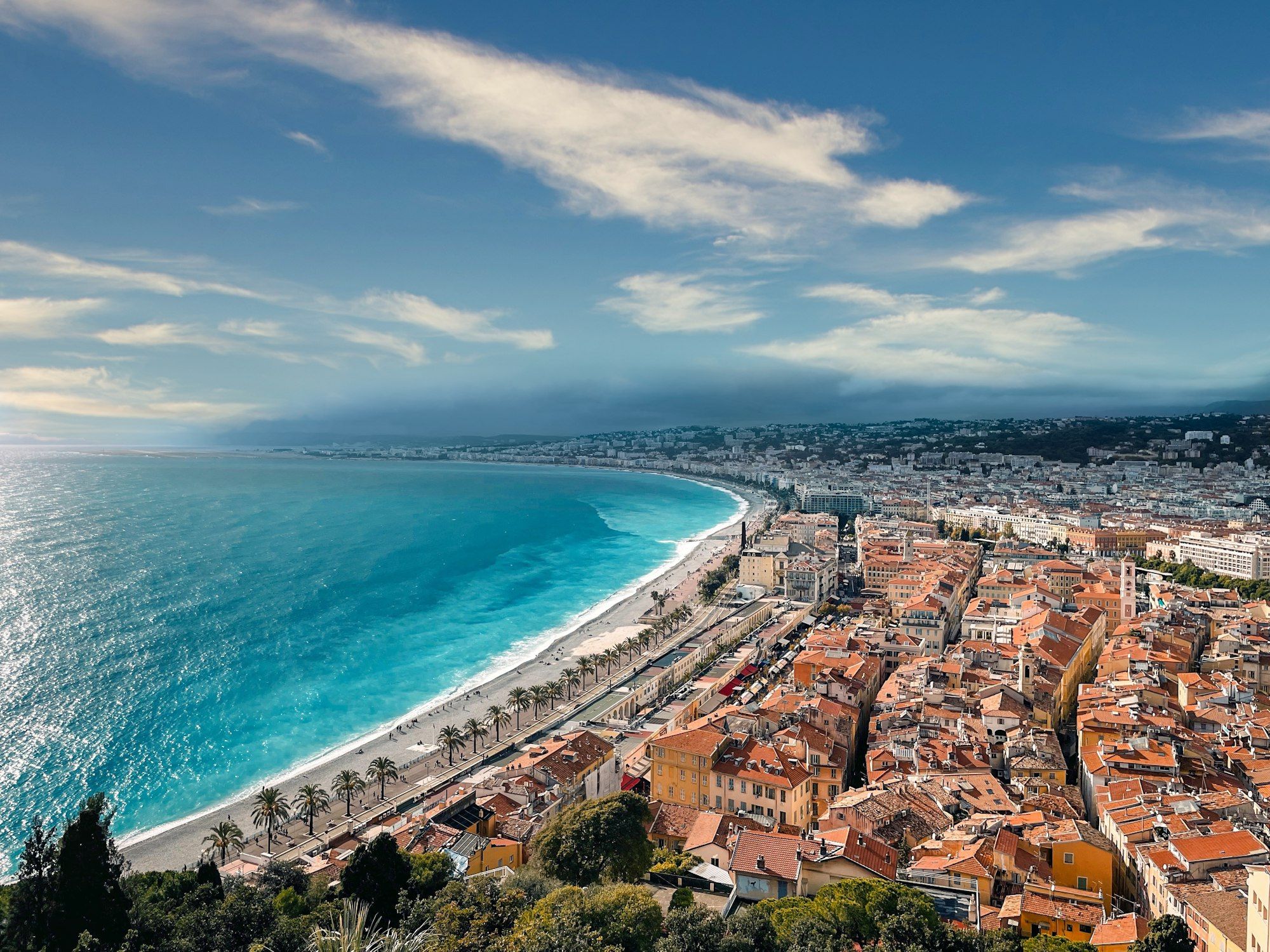 The Bay of Angels and the Promenade des Anglais in Nice, seen from above the old town's terracotta roofs