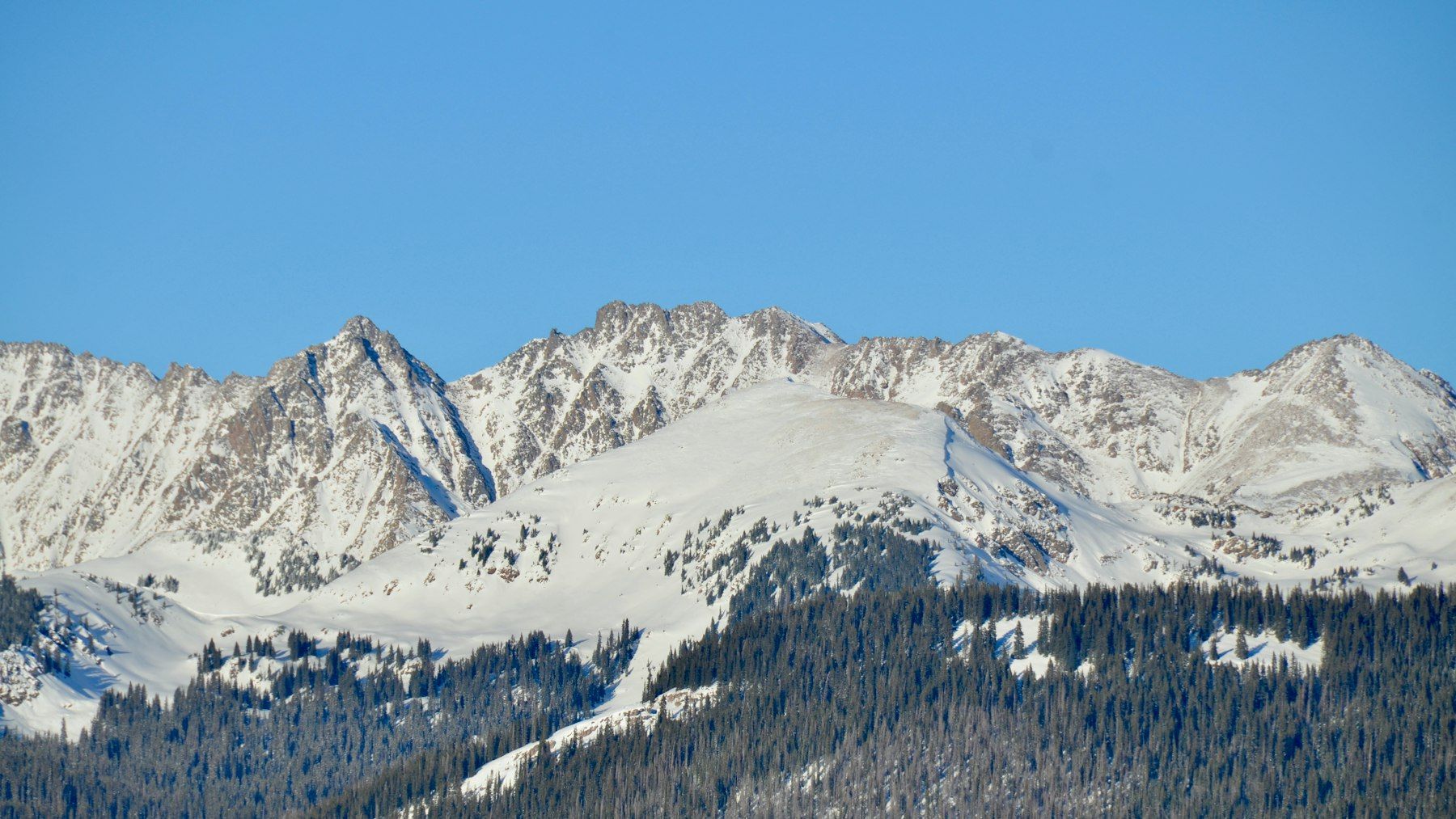 Snow-covered mountains near Vail, Colorado, under a clear blue sky